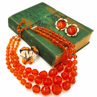 West Germany Orange Beaded Necklace With Enameled Brooch and Sarah Coventry Earrings at bitchinretro.com